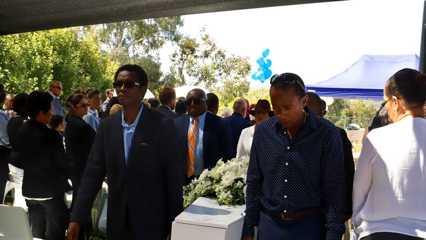 Mourners sung in Swahili as the coffins were carried out