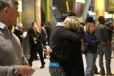 Reunited at last: Richard Young hugs his wife Sarah as she arrives at Heathrow after being stranded in Vancouver