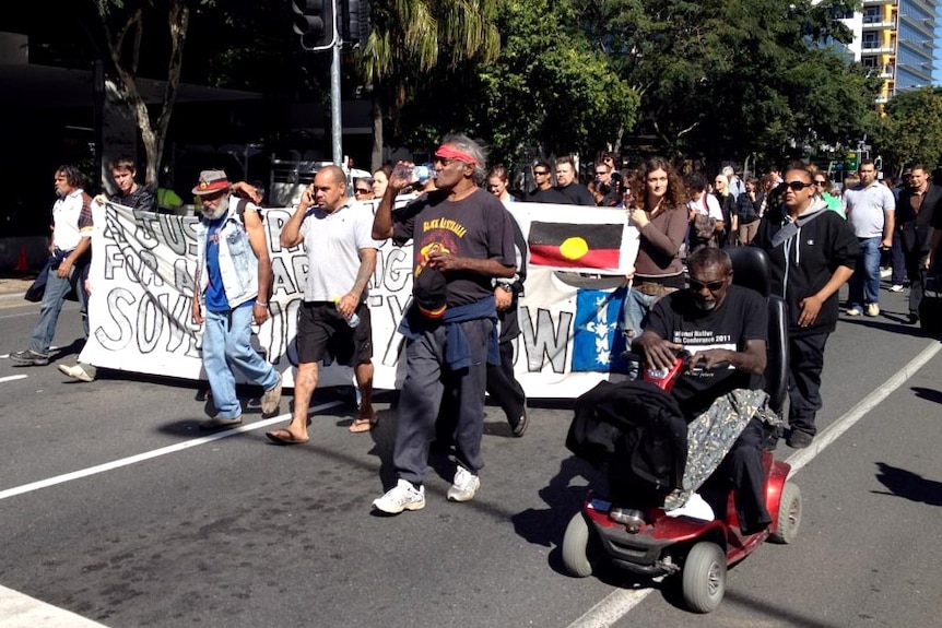 Protesters march through South Brisbane after the Aboriginal tent embassy was dismantled.