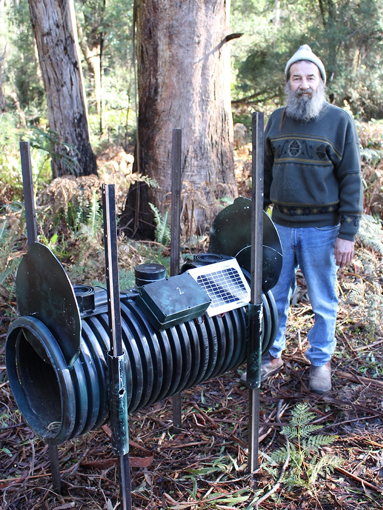 Kevin Knowles with cat-proof wildlife trap.