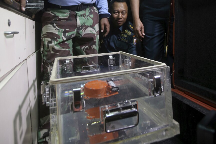 Navy personnel show the recovered flight data recorder of the Lion Air jet.