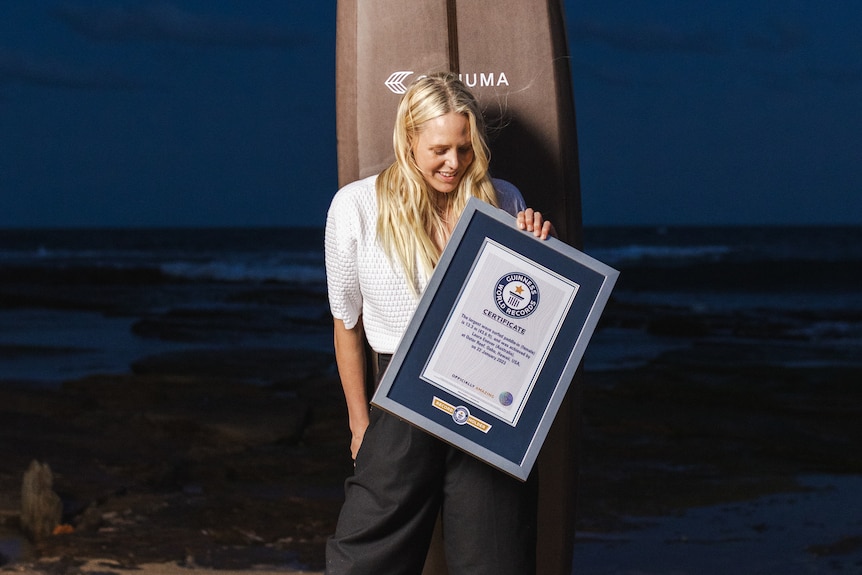 Laura Enever poses with her board and world record