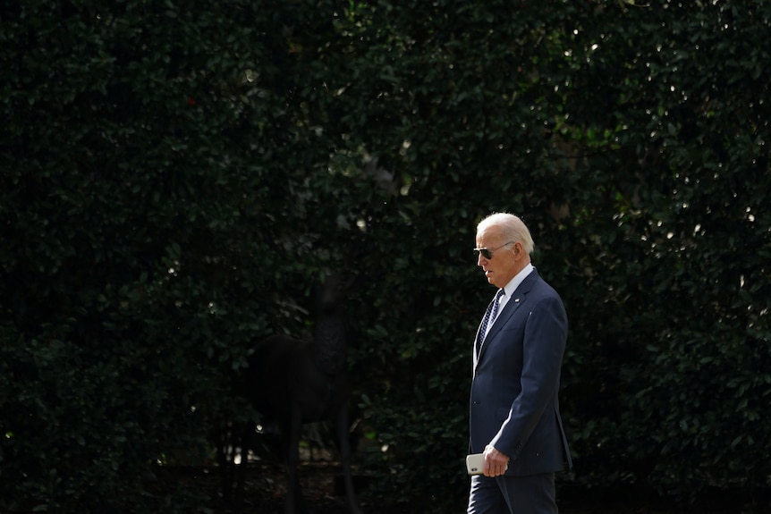 Joe Biden walks at the White House.
