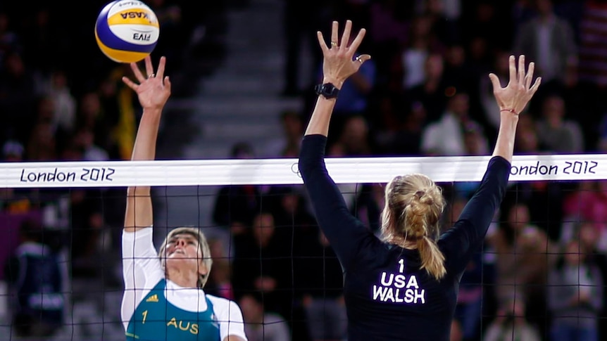 Kerri Walsh Jennings (front) challenges Natalie Cook during the women's beach volleyball.