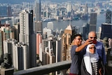 Tourists take selfies at the Peak in Hong Kong, China.