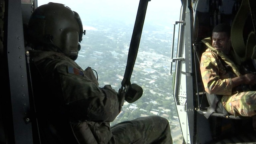 PNG defence personnel in a helicopter