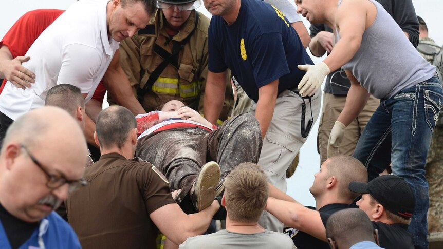 Rescuers carry tornado victim on stretcher