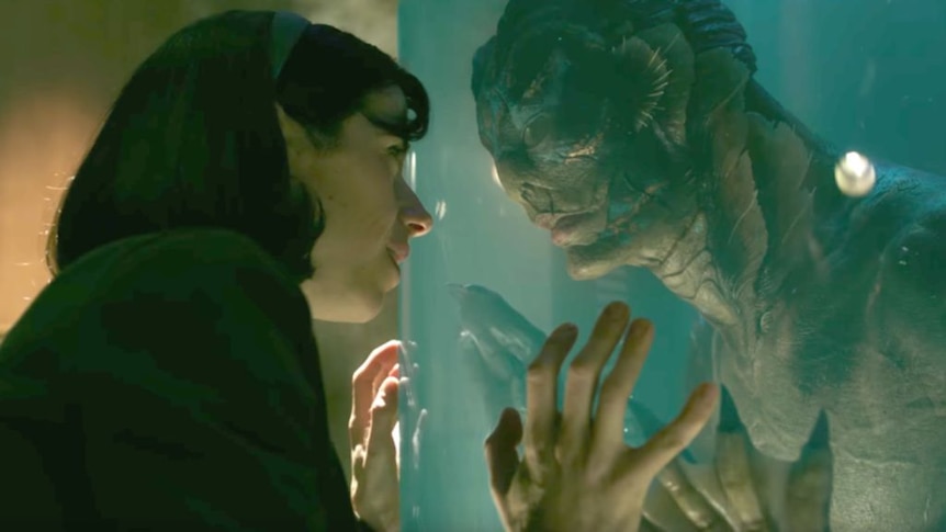A still image from the film Shape of Water with a woman and amphibious creature.