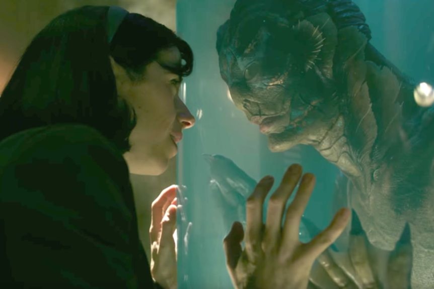 A still image from the film Shape of Water with a woman and amphibious creature.