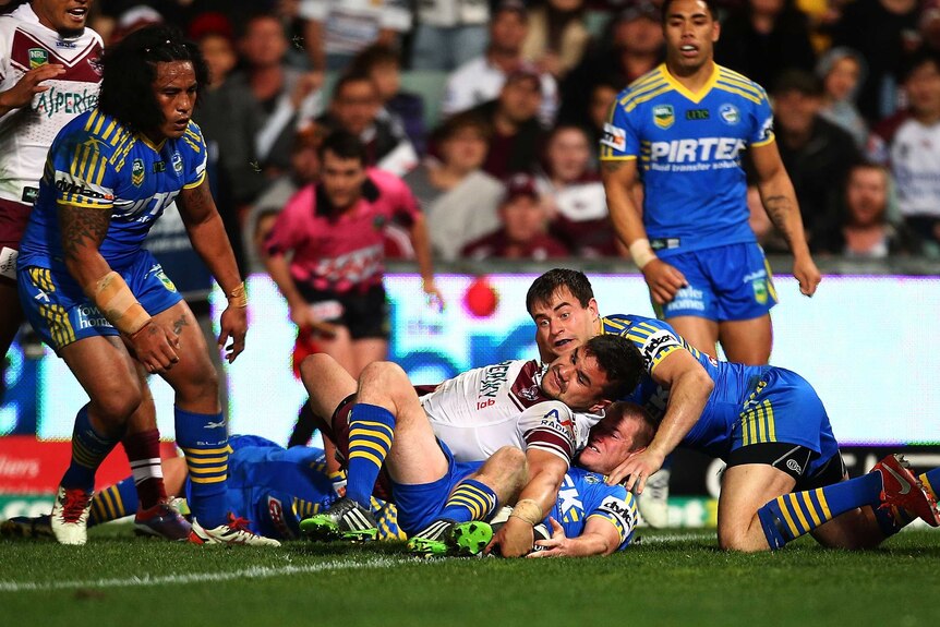 Early try ... Justin Horo stretches out to score for the Sea Eagles