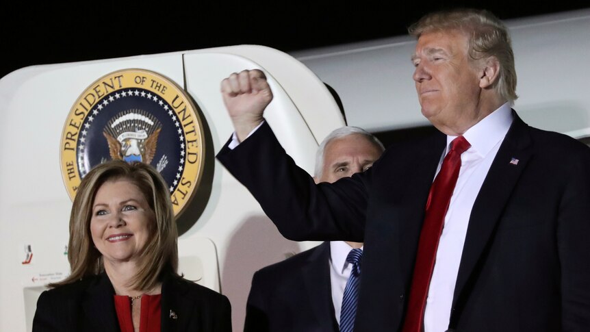 US President Donald Trump gestures next to Tennessee Republican candidate for US Senate Marsha Blackburn.