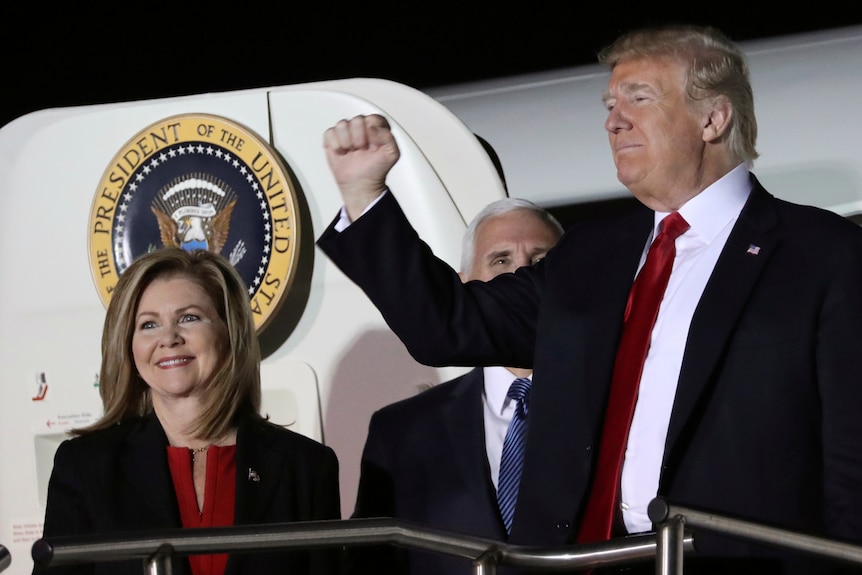 US President Donald Trump gestures next to Tennessee Republican candidate for US Senate Marsha Blackburn.