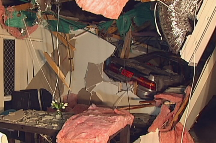 Car goes through roof of Brisbane home