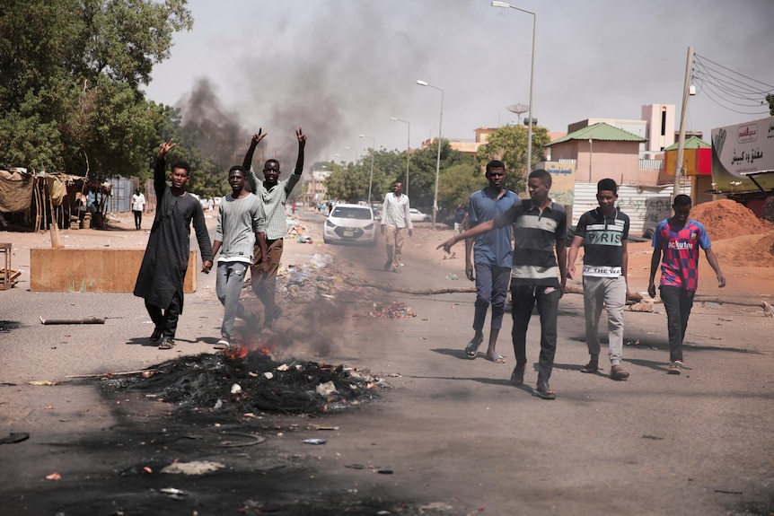Protesters burn tires during a protest against the military coup in Khartoum, October 26, 2021.