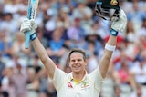 Steve Smith lifts his bat and helmet into the air to celebrate scoring a century.