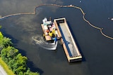 Machine dredging in the water.