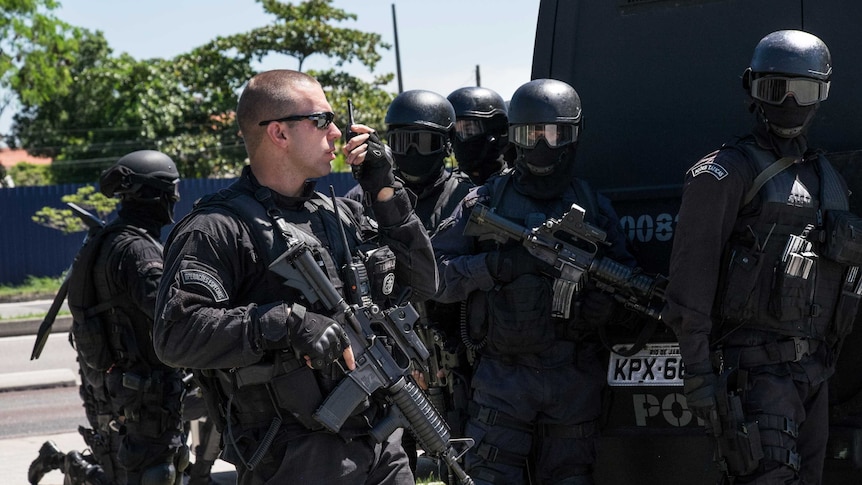 Brazilian paramilitary police elite unit personnel stand by during a drill