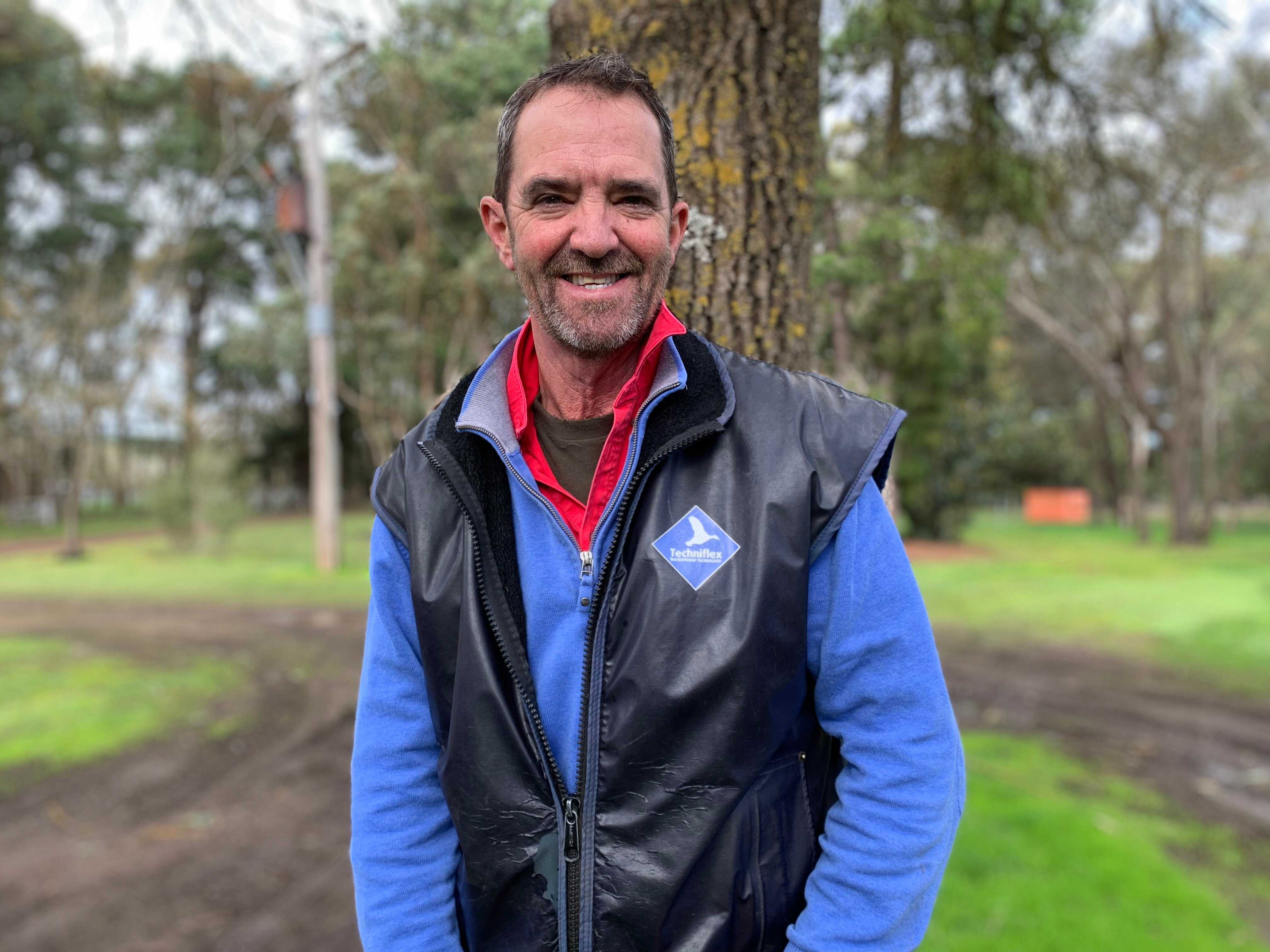 Photo of a man smiling on a farm