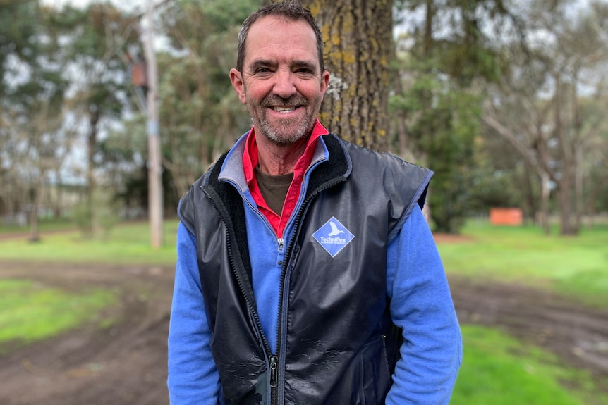 Photo of a man smiling on a farm