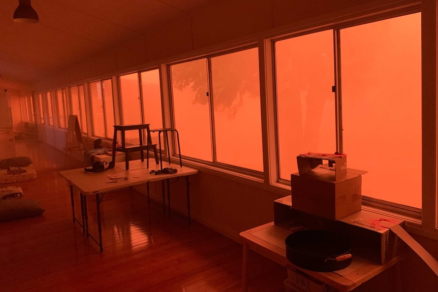 Red, dusty skies through the windows of a school room