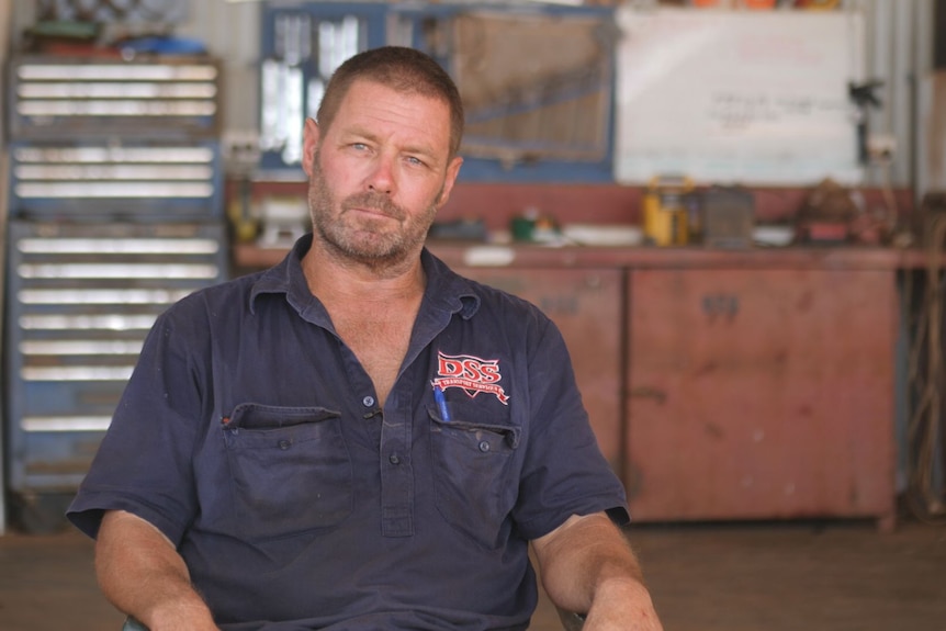 Transport Operator Stuart Kempton seated in a workshop. 