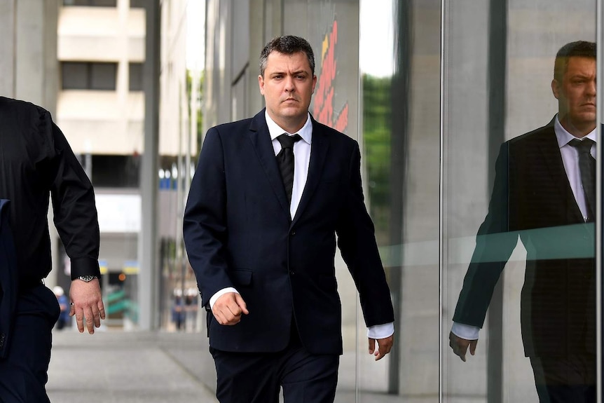 Matt James Nolan leaves court wearing suit.