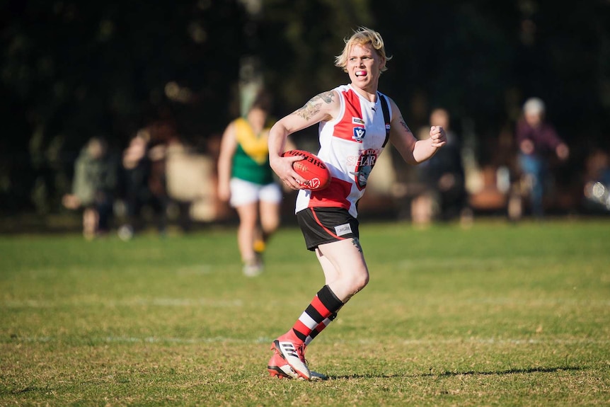 Transgender woman in action on the football field