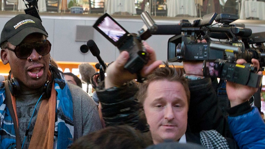 Entrepreneur Michael Spavor, centre, is seen with former NBA star Dennis Rodman on the way to a flight to North Korea.