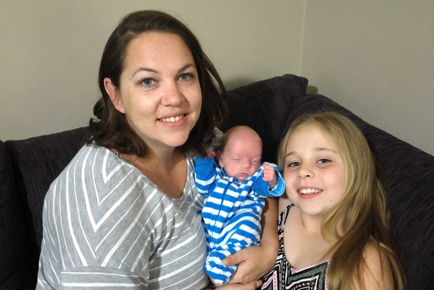 Nine-year-old Madison Dunsdon sitting with her mother, Kylie Row, and baby brother Harley