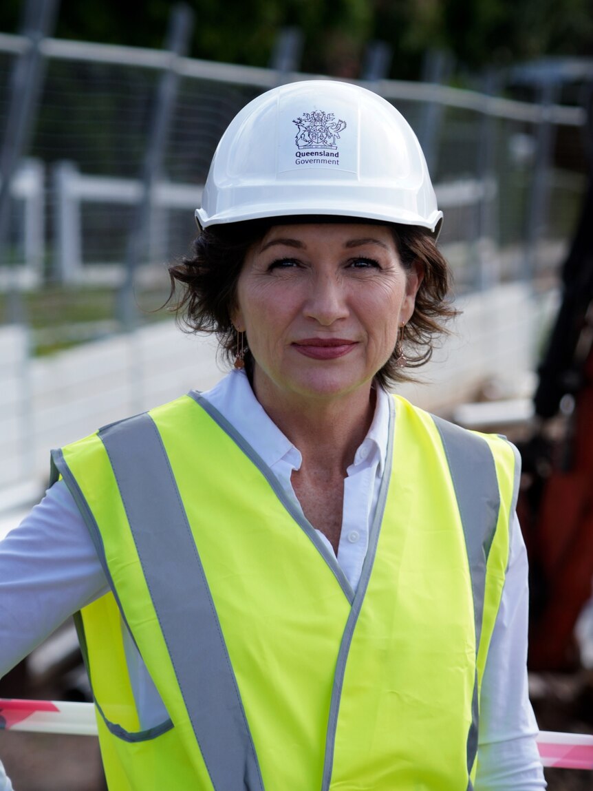Leeanne Enoch in a high-vis vest and a hard hat with a Queensland Government stamp on it