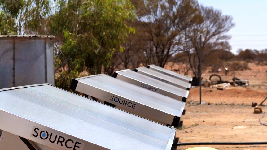 six solar hydro panel units lined up with trees in background