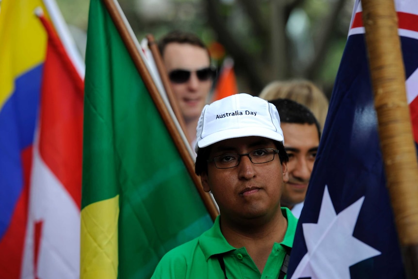 People wait to be sworn as an Australian during a citizenship ceremony as part of the Australia Day festivities in Sydney