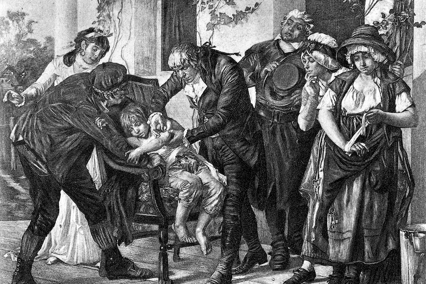 A black and white drawing showing a man administering to a small boy, with several onlookers
