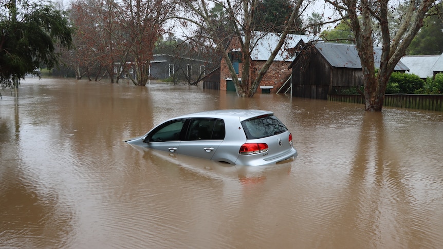 Car and houses submerged by flood waters in Sydney