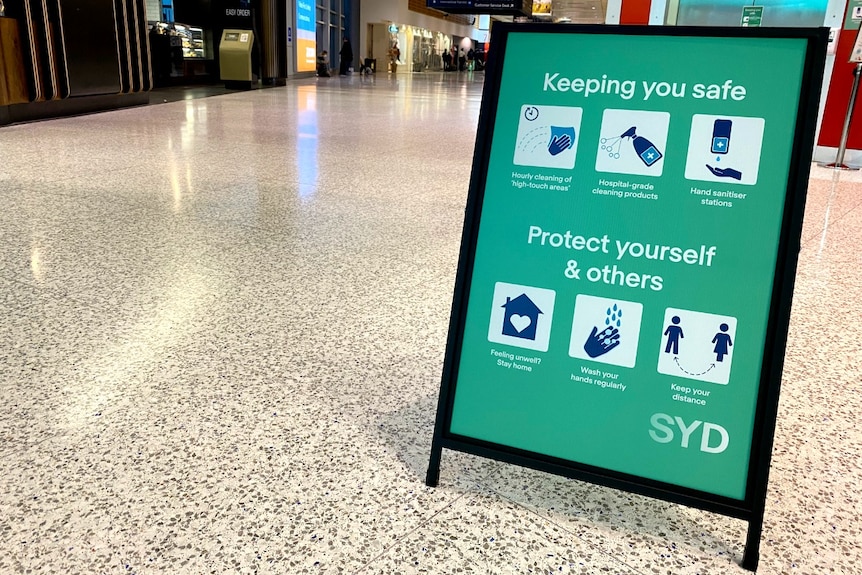 A green sign saying "keeping you safe" with white squares featuring graphics of hand hygiene practices.