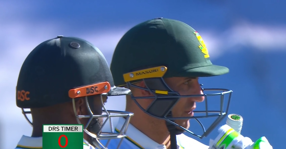 A close up of a cricketer in helmet looking to the side with a timer in the bottom left of screen that says zero.