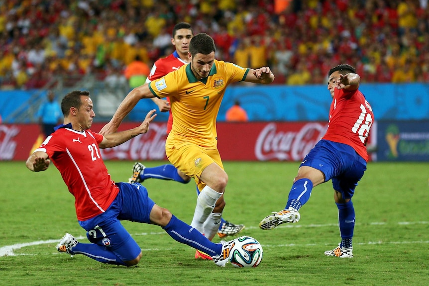 Mathew Leckie dribbles through the Chile defence