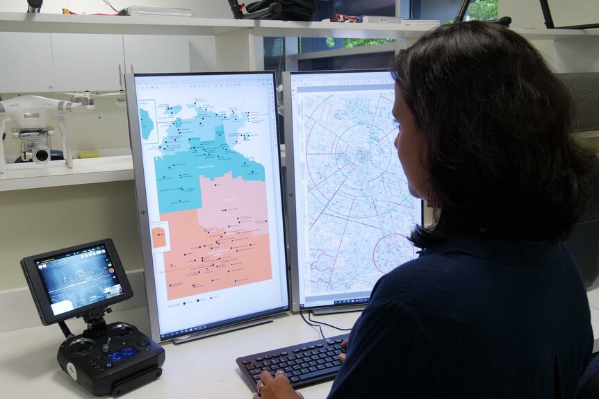 A researcher looks at drone flight paths on a computer.