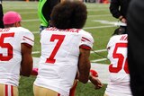 San Francisco 49ers quarterback Colin Kaepernick kneels for the national anthem