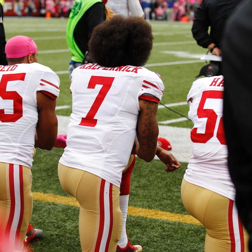 San Francisco 49ers quarterback Colin Kaepernick kneels for the national anthem