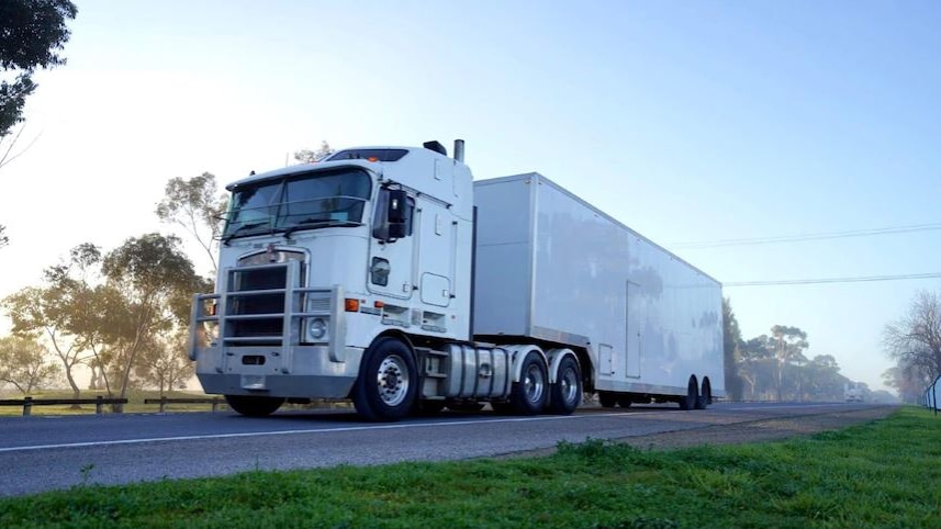 A heavy truck driving on the road.