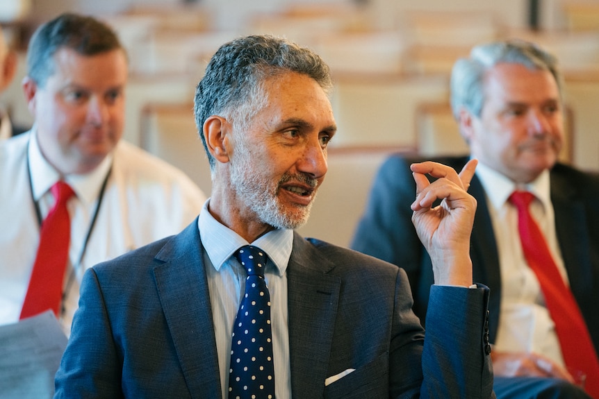 A mid-shot of a smiling Labor MP Tony Buti in a suit and tie.