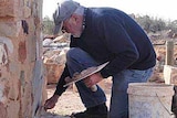 Volunteer Bob Moffatt working on his great grandparents' home in Farina