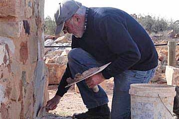 Volunteer Bob Moffatt working on his great grandparents home in Farina