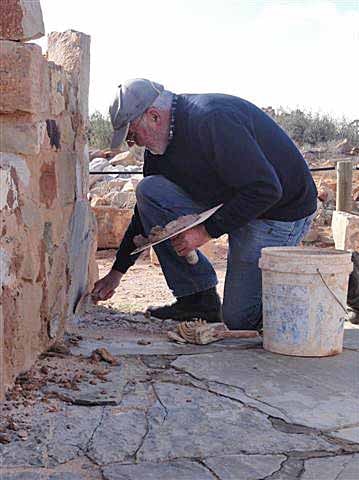 Volunteer Bob Moffatt working on his great grandparents' home in Farina