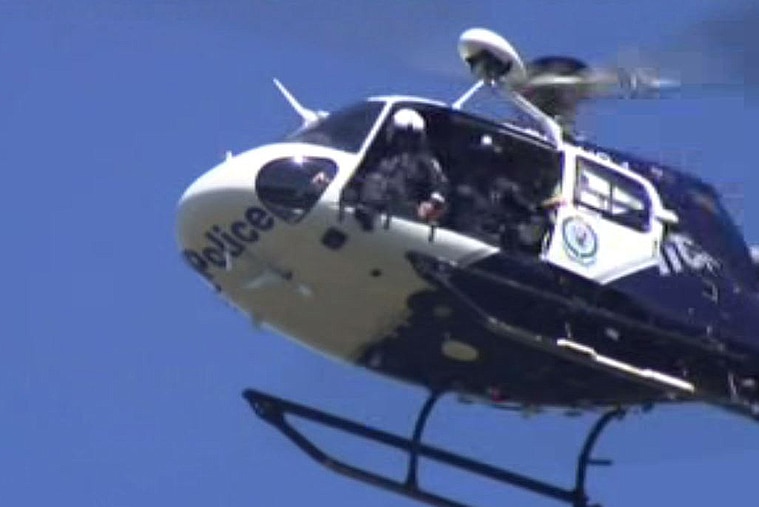 NSW Police helicopter flies overhead.