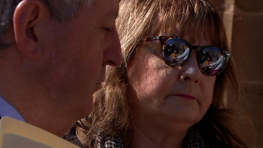 A woman wearing sunglasses with a man next to her