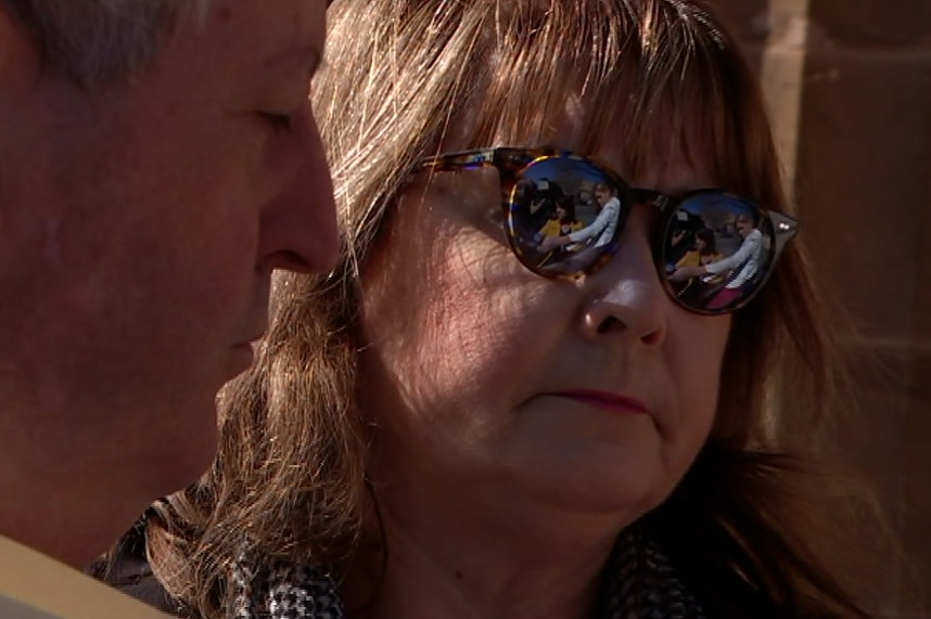 A woman wearing sunglasses with a man next to her