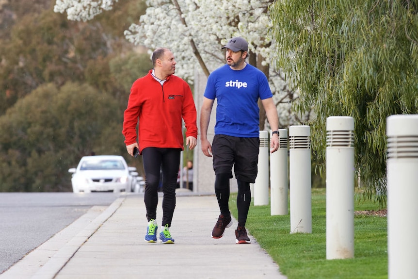 Josh Frydenberg and Ed Husic take their morning walk through the streets of Canberra.