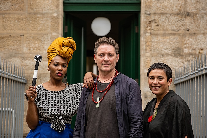 Colour photo of artists Lhola Amira, Brook Andrew and Lisa Reihana posing at the National Art School in Sydney.